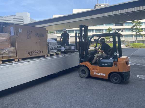 Forklift unloading crated exhibition items
