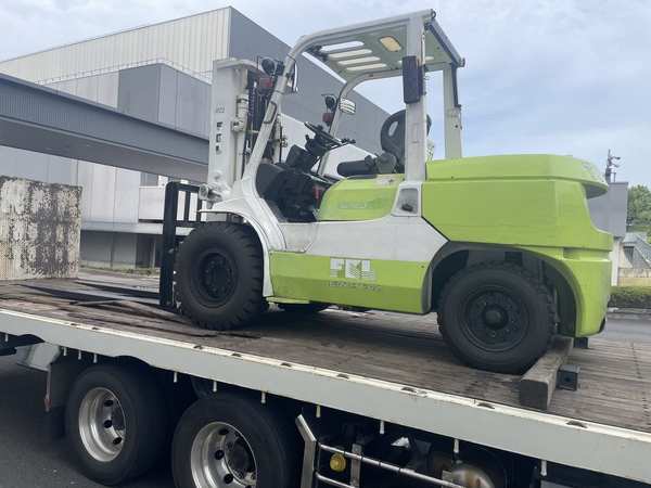 Specialized forklift transported on flatbed truck