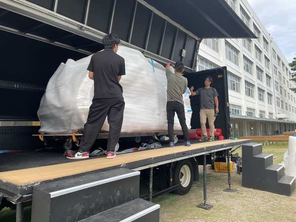 Team loading exhibition items onto truck