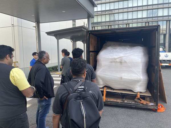 Team unloading wrapped exhibition cargo